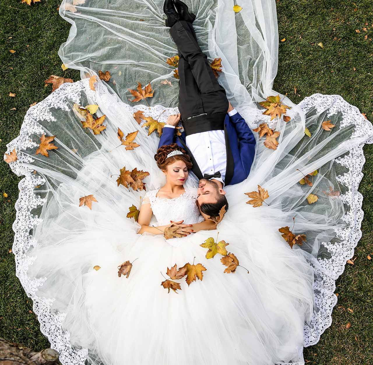Romantic newlyweds amidst golden autumn leaves