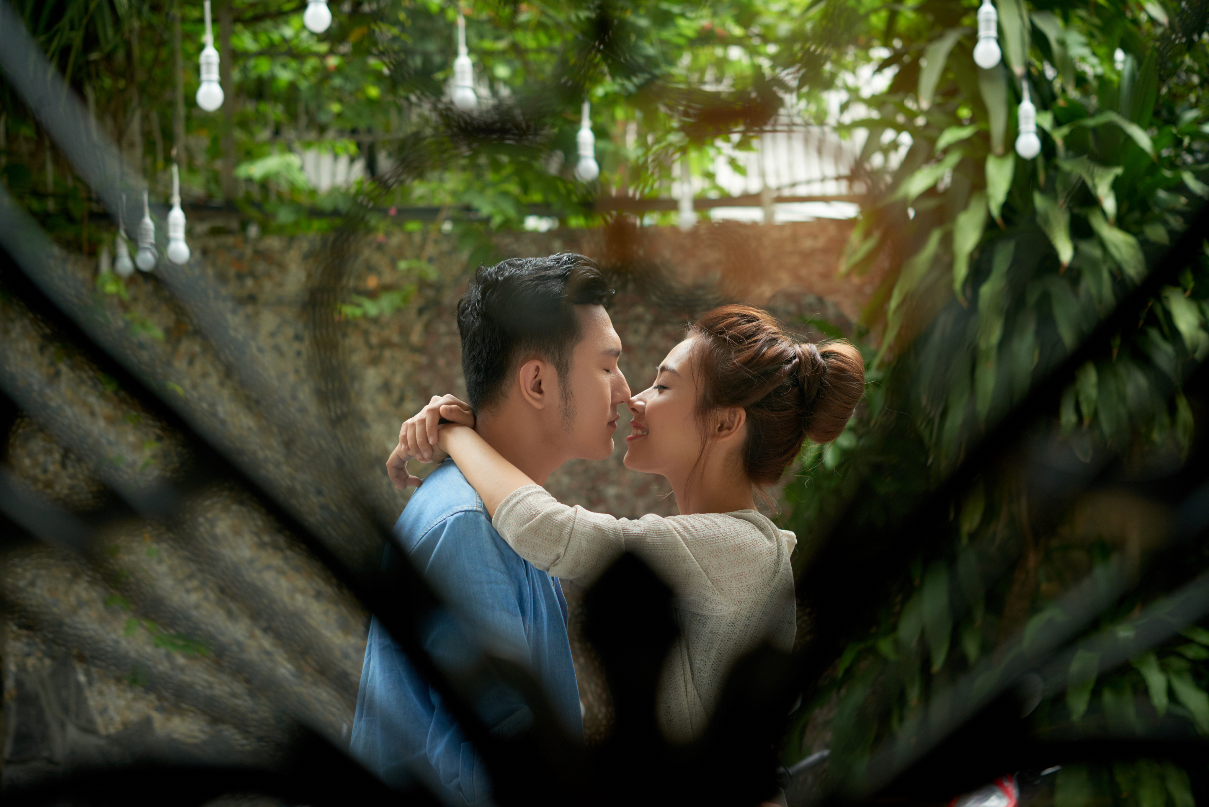 Romantic couple kissing in luxury resort garden